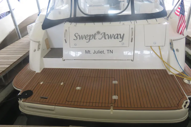 Swept Away Yacht Photos Pics 2007 Cruisers Yachts 420 Express docked, featuring teak deck and "Swept Away" nameplate.