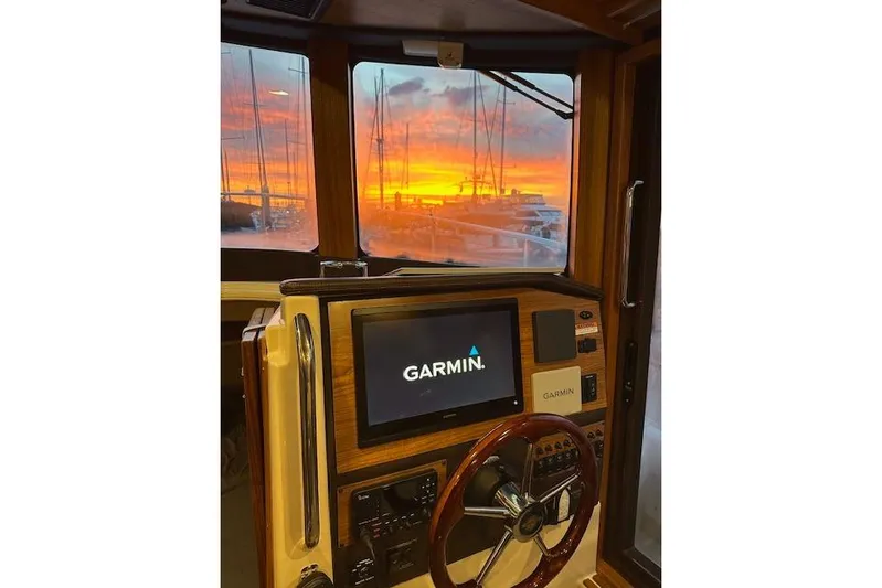 Maquinna Yacht Photos Pics 2024 Ranger Tugs R-31 CB helm with Garmin display, sunset view through windows.