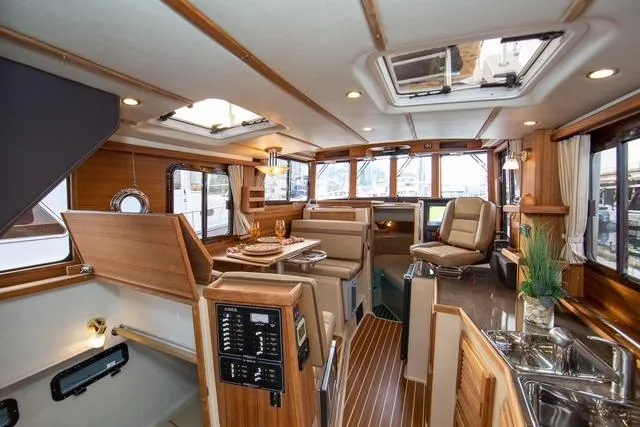 Maquinna Yacht Photos Pics 2024 Ranger Tugs R-31 CB interior with elegant wood finish and modern amenities.