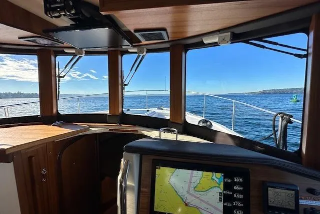Maquinna Yacht Photos Pics 2024 Ranger Tugs R-31 CB interior with navigation display, overlooking serene ocean view.