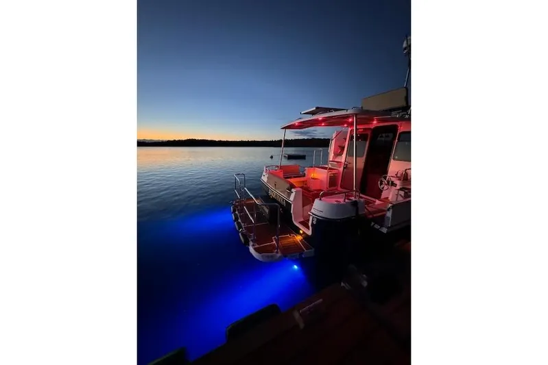 Maquinna Yacht Photos Pics 2024 Ranger Tugs R-31 CB boat illuminated at sunset on calm water.