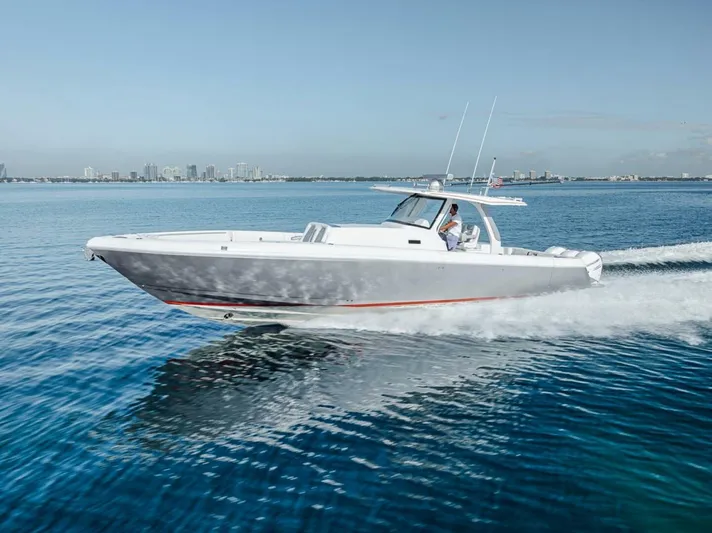  Yacht Photos Pics 2019 Intrepid 407 Panacea cruising on open water, city skyline in background.
