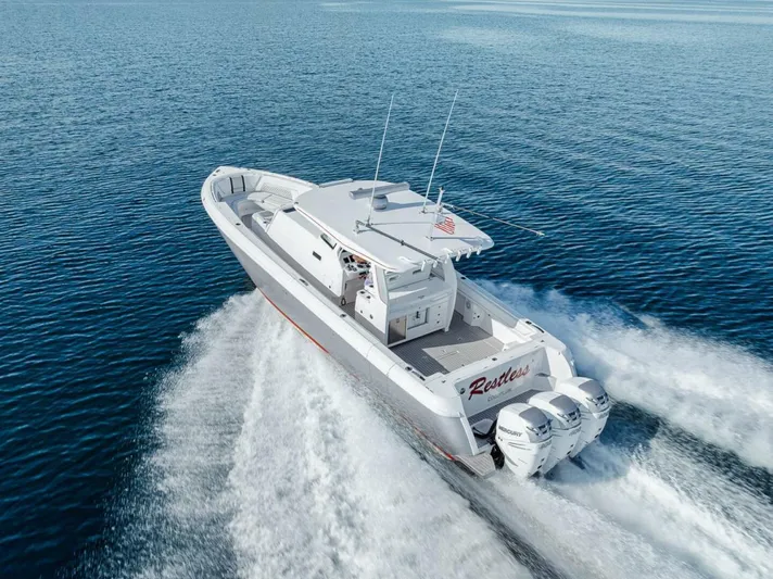  Yacht Photos Pics Intrepid 407 Panacea 2019 boat cruising on open water, rear view with triple engines.