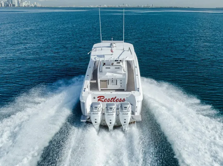  Yacht Photos Pics 2019 Intrepid 407 Panacea boat cruising on open water, rear view.