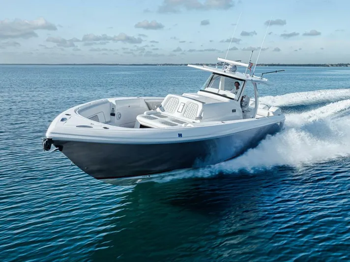  Yacht Photos Pics 2019 Intrepid 407 Panacea cruising on open water under a clear sky.