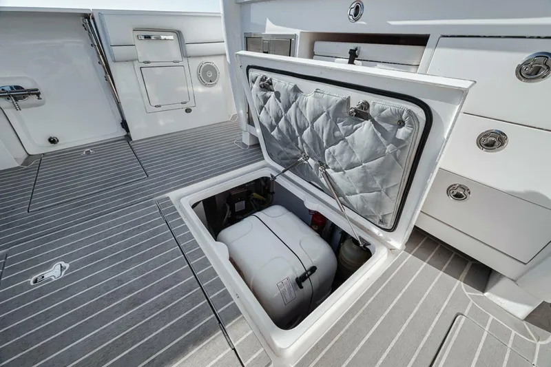  Yacht Photos Pics 2019 Intrepid 407 Panacea boat with open storage compartment on deck.