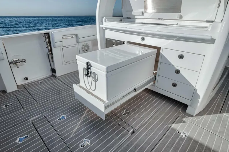  Yacht Photos Pics 2019 Intrepid 407 Panacea boat deck with storage compartment open, ocean in background.