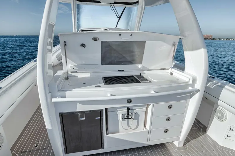  Yacht Photos Pics 2019 Intrepid 407 Panacea boat with sleek outdoor kitchen setup on deck.