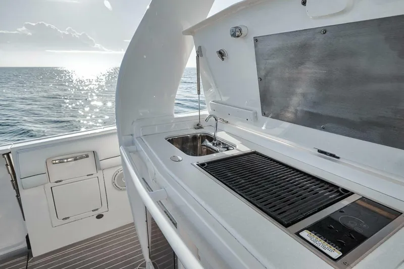  Yacht Photos Pics Outdoor kitchen on 2019 Intrepid 407 Panacea boat with sink and grill, ocean view.