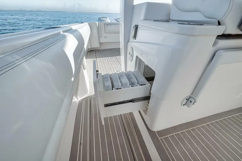  Yacht Photos Pics 2019 Intrepid 407 Panacea boat interior with open storage drawer, ocean view.