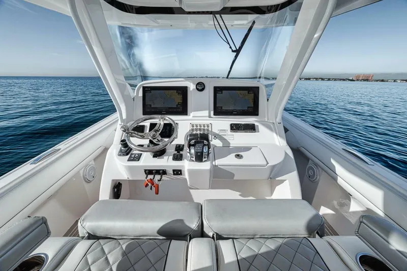 Yacht Photos Pics 2019 Intrepid 407 Panacea helm with dual screens, steering wheel, and ocean view.