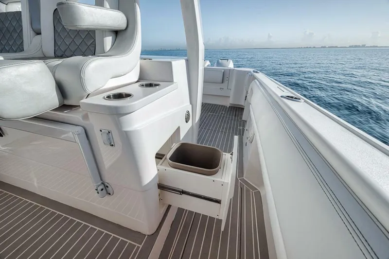  Yacht Photos Pics 2019 Intrepid 407 Panacea boat interior with seating and storage, on calm ocean waters.