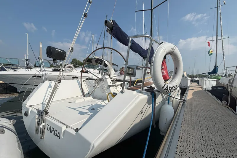 Targa Yacht Photos Pics 2008 Beneteau First 10R sailboat docked at marina, featuring a spacious cockpit and life ring.