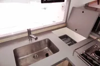 Modern kitchen area in a 2020 Leopard 43 Powercat, featuring a sleek sink and stove.