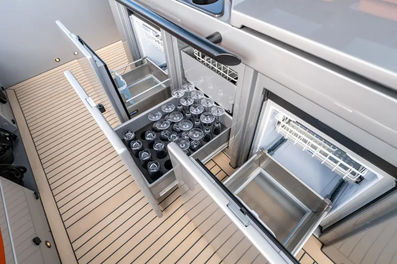  Yacht Photos Pics 2023 Vanquish Yachts Sports Line Outboard interior with open storage compartments and glassware.