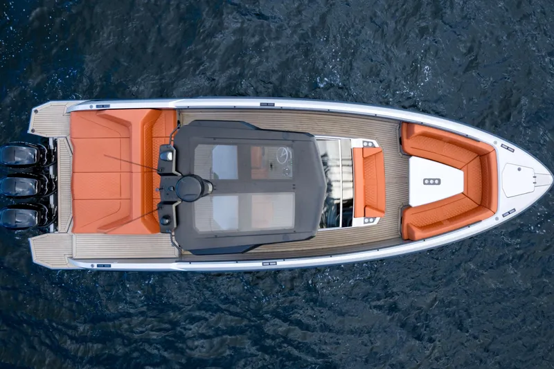  Yacht Photos Pics 2023 Vanquish Yachts Sports Line Outboard, aerial view, sleek design, orange seating, on water.
