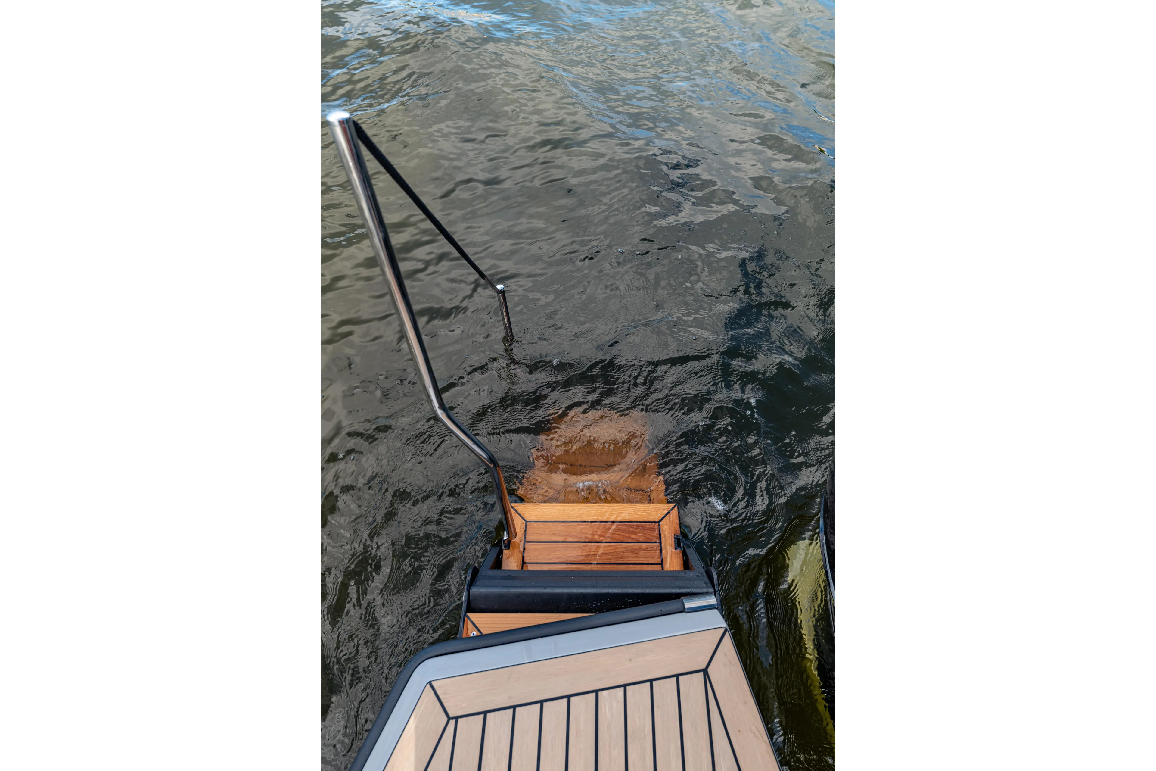 Yacht Photos Pics 2023 Vanquish Yachts Sports Line Outboard swim platform with ladder in water.