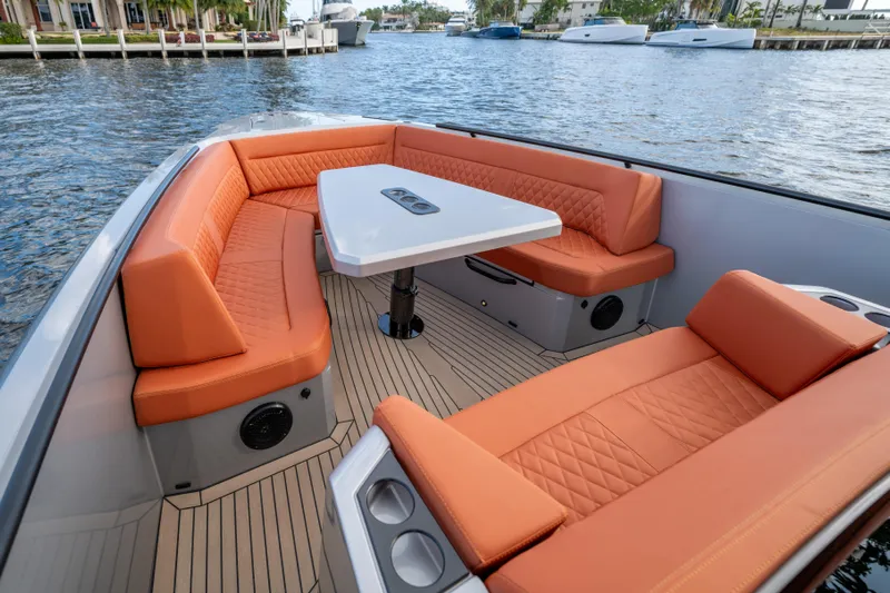  Yacht Photos Pics Luxurious 2023 Vanquish Yachts Sports Line Outboard with orange seating and sleek design.