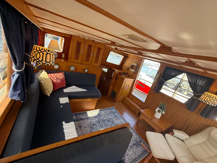 Aja Marie Yacht Photos Pics Interior of 1986 Marine Trader Tri Cabin with cozy seating and nautical decor.