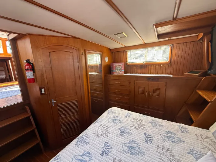 Aja Marie Yacht Photos Pics 1986 Marine Trader Tri Cabin interior with wood paneling, bed, and storage cabinets.