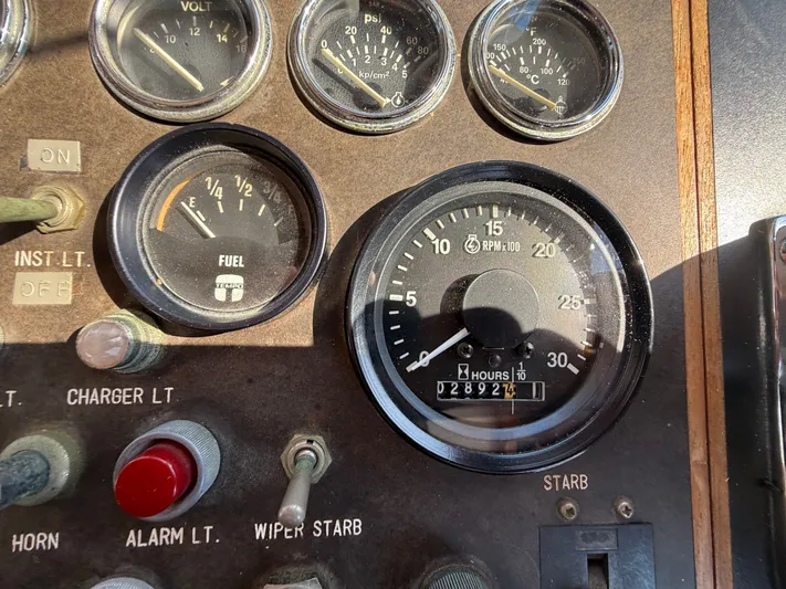 Aja Marie Yacht Photos Pics 1986 Marine Trader Tri Cabin dashboard with gauges and controls, including fuel and RPM indicators.