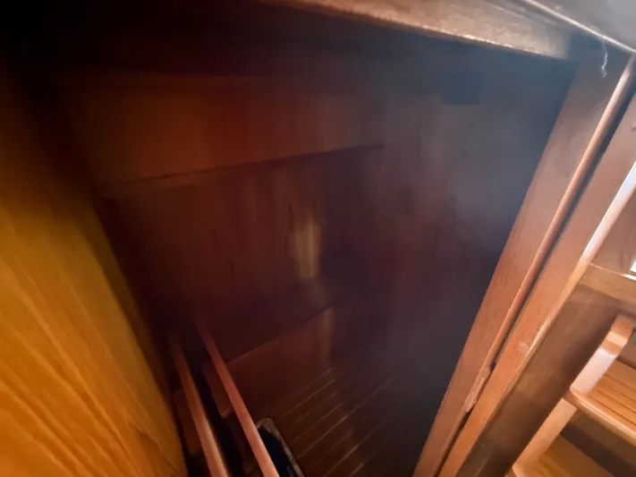 Aja Marie Yacht Photos Pics 1986 Marine Trader Tri Cabin interior with wooden finish and storage space.