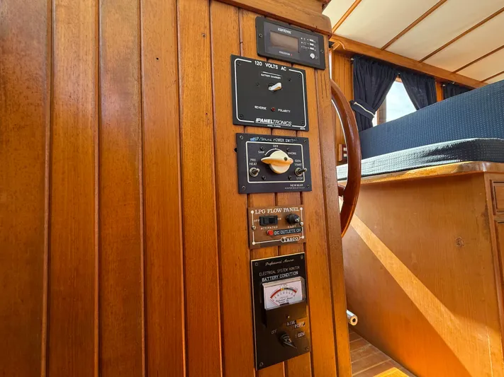 Aja Marie Yacht Photos Pics 1986 Marine Trader Tri Cabin interior with control panels and wooden finish.
