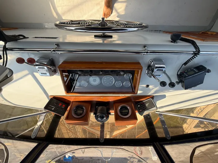 Aja Marie Yacht Photos Pics 1986 Marine Trader Tri Cabin helm with gauges, controls, and communication equipment.