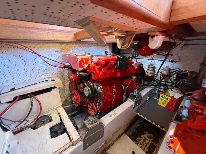 Aja Marie Yacht Photos Pics Engine room of 1986 Marine Trader Tri Cabin with red engine and maintenance tools.