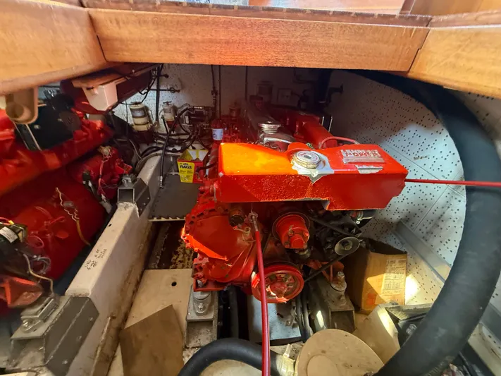 Aja Marie Yacht Photos Pics Engine room of 1986 Marine Trader Tri Cabin with visible red engine components.