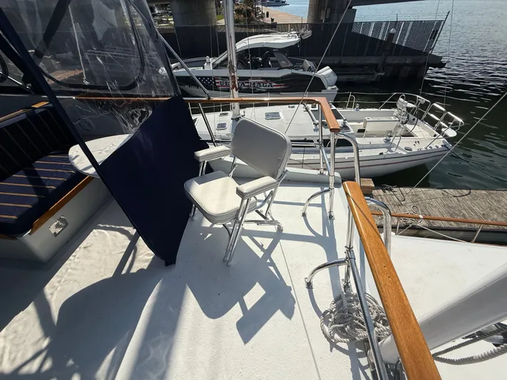 Aja Marie Yacht Photos Pics 1986 Marine Trader Tri Cabin yacht deck with seating and view of docked boats.