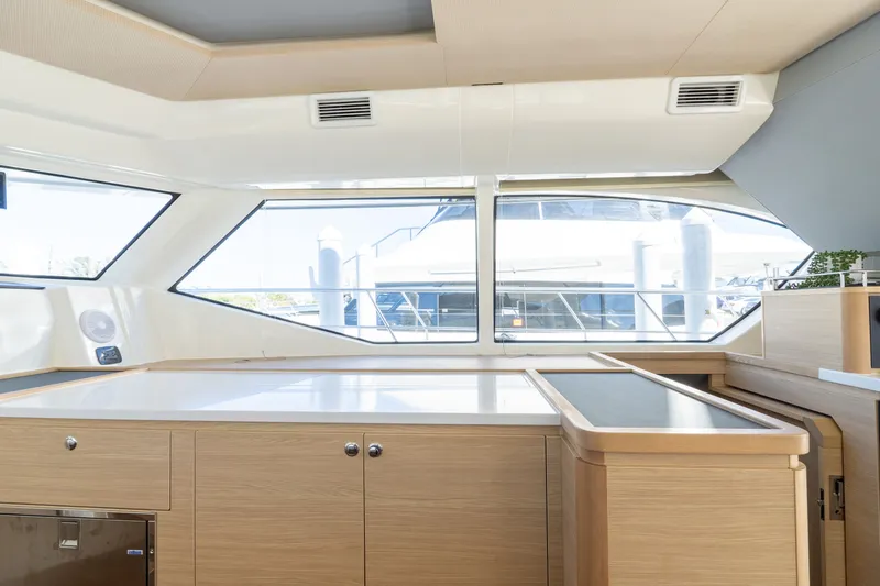  Yacht Photos Pics Interior of 2023 Aquila 44 Yacht with modern wooden cabinetry.
