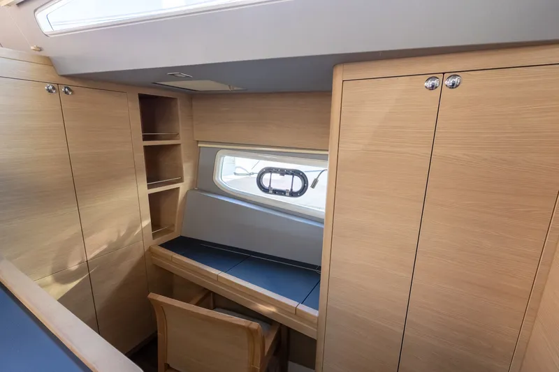 Yacht Photos Pics Interior of 2023 Aquila 44 Yacht with desk and wooden cabinets.