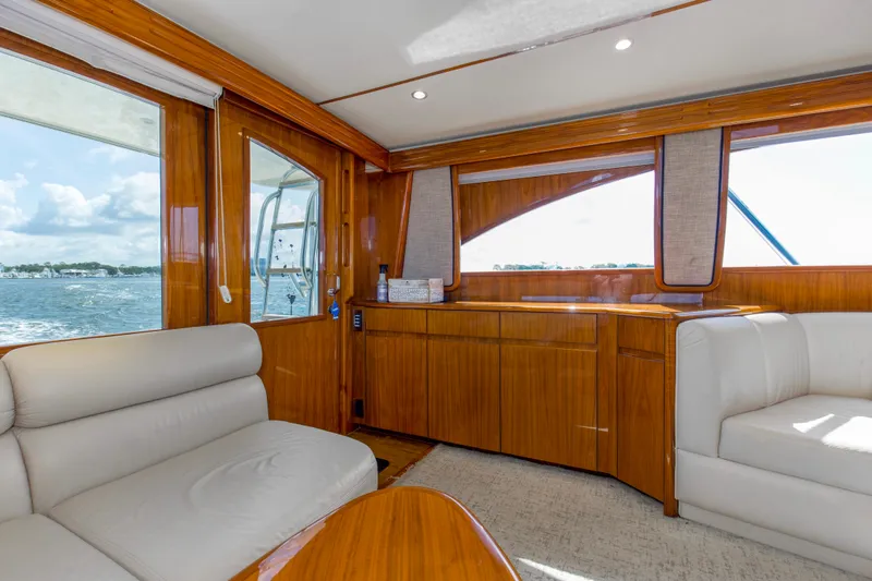 Reel Petty Yacht Photos Pics Luxurious interior of 2017 Viking 48 Convertible yacht with plush seating and wooden finishes.