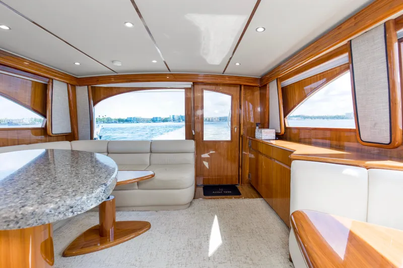 Reel Petty Yacht Photos Pics Luxurious interior of 2017 Viking 48 Convertible yacht with elegant wood finishes and waterfront view.