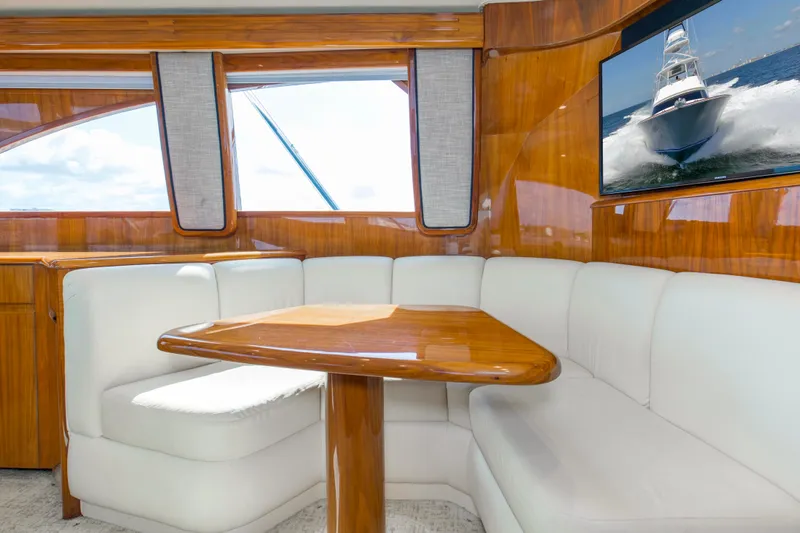 Reel Petty Yacht Photos Pics Luxurious interior of 2017 Viking 48 Convertible yacht with plush seating and wooden table.