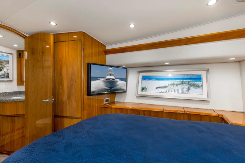 Reel Petty Yacht Photos Pics Luxurious cabin interior of 2017 Viking 48 Convertible yacht with wood paneling and modern decor.