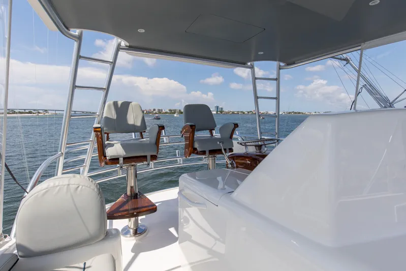 Reel Petty Yacht Photos Pics Flybridge of 2017 Viking 48 Convertible yacht with helm chairs, overlooking the ocean.