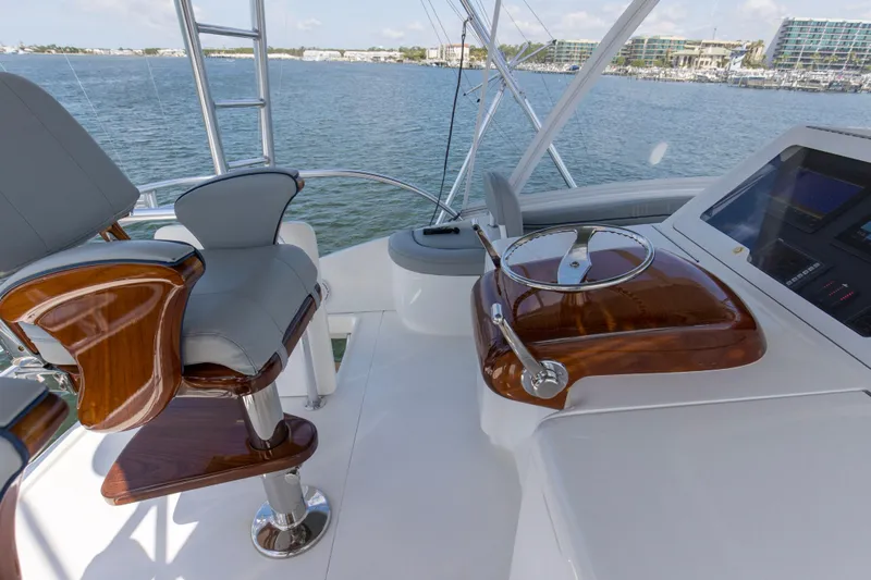 Reel Petty Yacht Photos Pics 2017 Viking 48 Convertible yacht helm with luxurious seating and controls, overlooking serene waters.