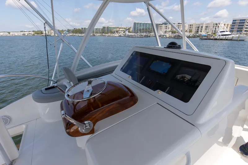 Reel Petty Yacht Photos Pics 2017 Viking 48 Convertible yacht helm with modern controls, docked in a marina.