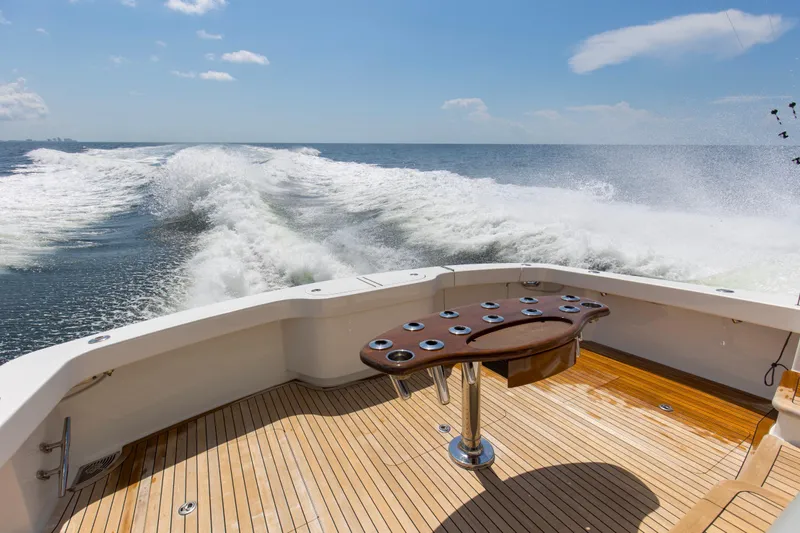 Reel Petty Yacht Photos Pics 2017 Viking 48 Convertible yacht cruising on open water, featuring a spacious teak deck.