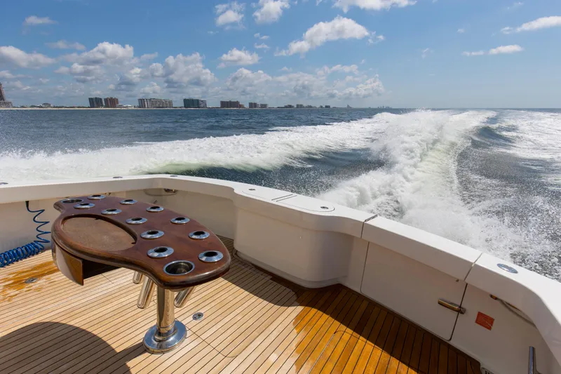 Reel Petty Yacht Photos Pics Viking 48 Convertible 2017 yacht cruising, wooden deck, ocean view, wake trail, clear sky.