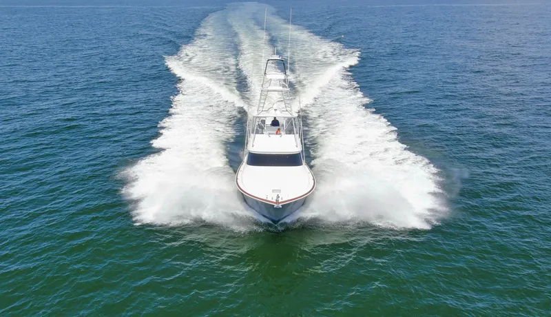 Reel Petty Yacht Photos Pics 2017 Viking 48 Convertible yacht cruising on open water, creating a dynamic wake.