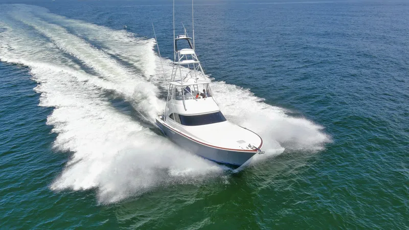 Reel Petty Yacht Photos Pics 2017 Viking 48 Convertible yacht cruising swiftly on open water.