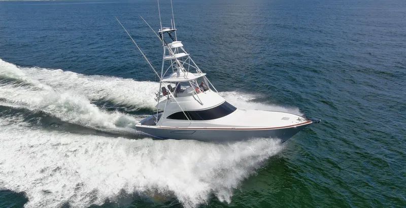 Reel Petty Yacht Photos Pics 2017 Viking 48 Convertible yacht cruising on open water, creating a dynamic wake.