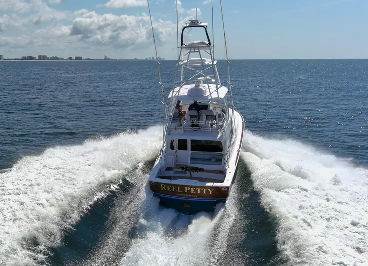 Reel Petty Yacht Photos Pics 2017 Viking 48 Convertible yacht cruising on open sea, creating a wake.