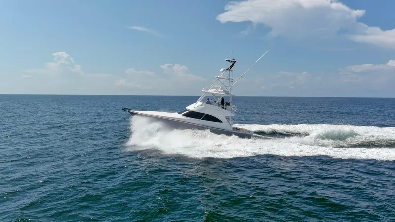 Reel Petty Yacht Photos Pics 2017 Viking 48 Convertible yacht cruising on open sea under clear skies.