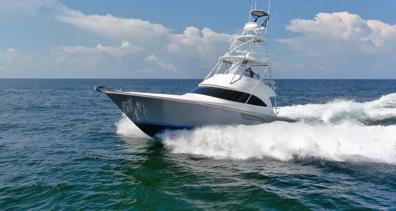 Reel Petty Yacht Photos Pics 2017 Viking 48 Convertible yacht cruising on open sea under clear skies.