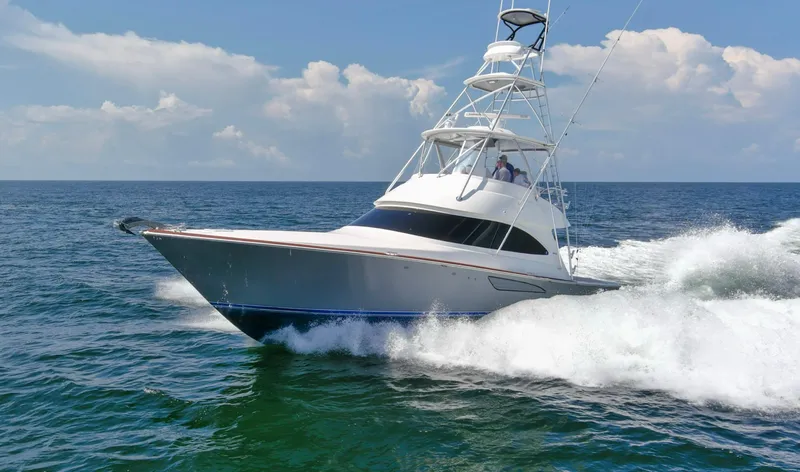 Reel Petty Yacht Photos Pics 2017 Viking 48 Convertible yacht cruising on open sea under clear skies.