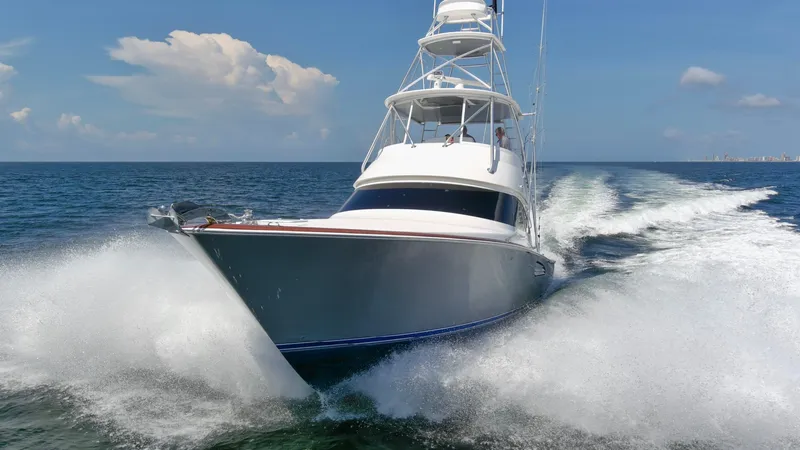 Reel Petty Yacht Photos Pics 2017 Viking 48 Convertible yacht cruising swiftly on open water.